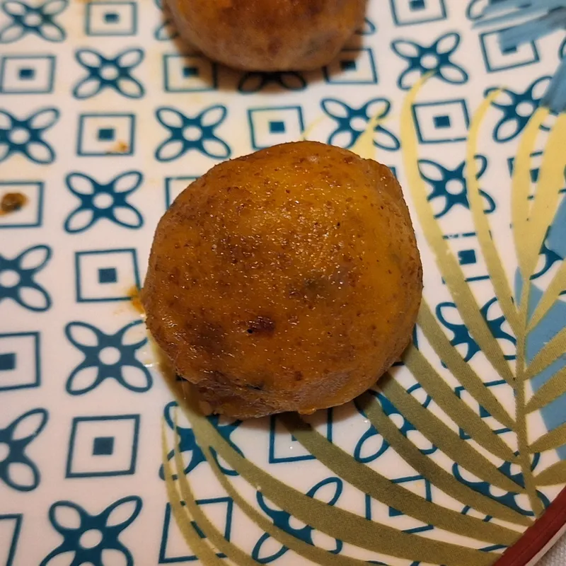 Close-up of a golden pumpkin ball with a lightly caramelised crust.