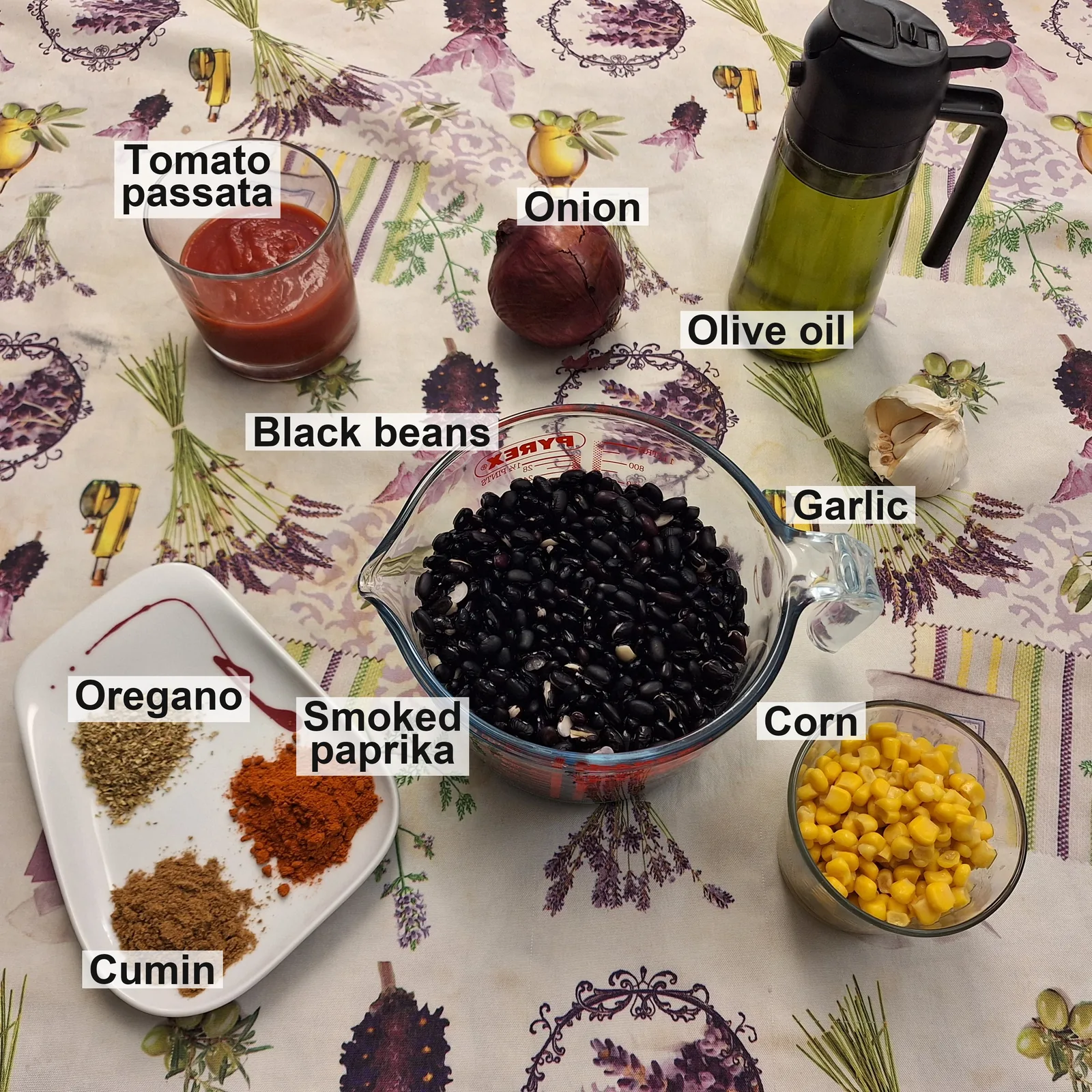 The labelled ingredients: tomato passata, onion, olive oil, garlic, black beans, corn, oregano, smoked paprika and cumin.